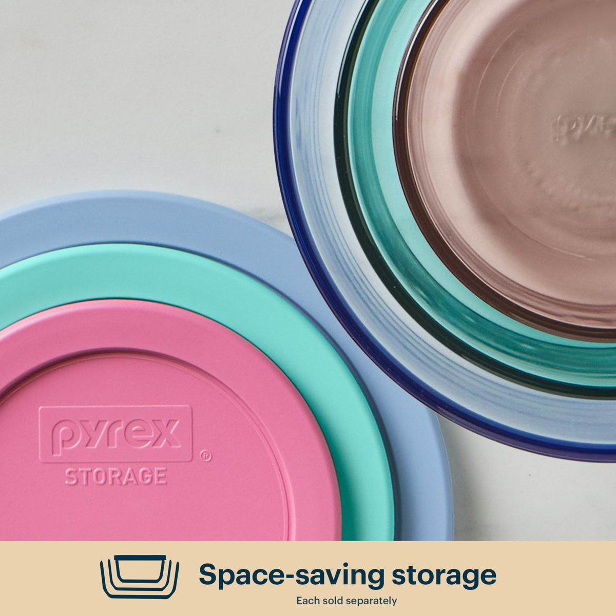 Pyrex storage containers with colorful lids on a light background