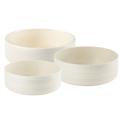 Set of three white ceramic bowls with ribbed texture on a white background