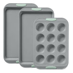 Set of three gray baking trays with green silicone grips on a white background