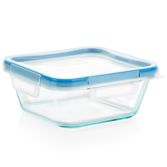 Clear glass food container with blue lid on a white background