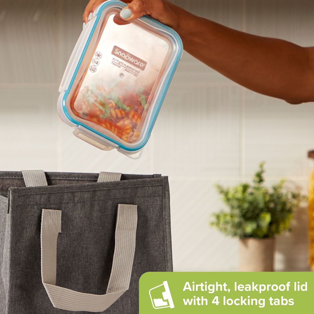 Hand holding a Shapeways food container with an airtight lid, next to a gray tote bag.