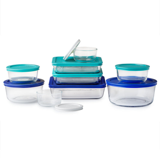 Set of clear food storage containers with blue lids on a white background